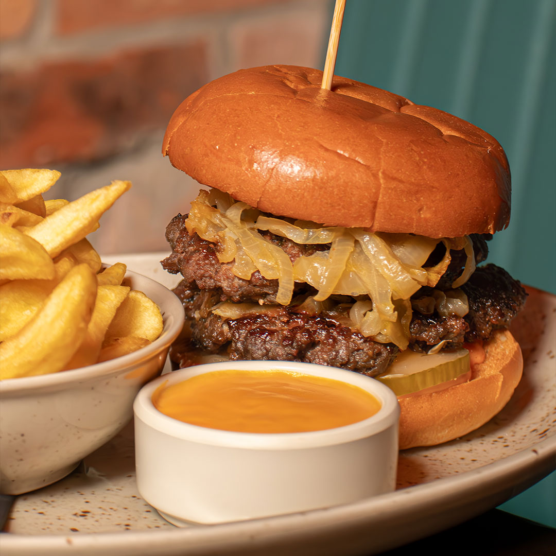 Graphic promoting the midweek burger and pint deal at The Old Quarter: any burger and any pint for €20, available Tuesday to Thursday in Limerick.