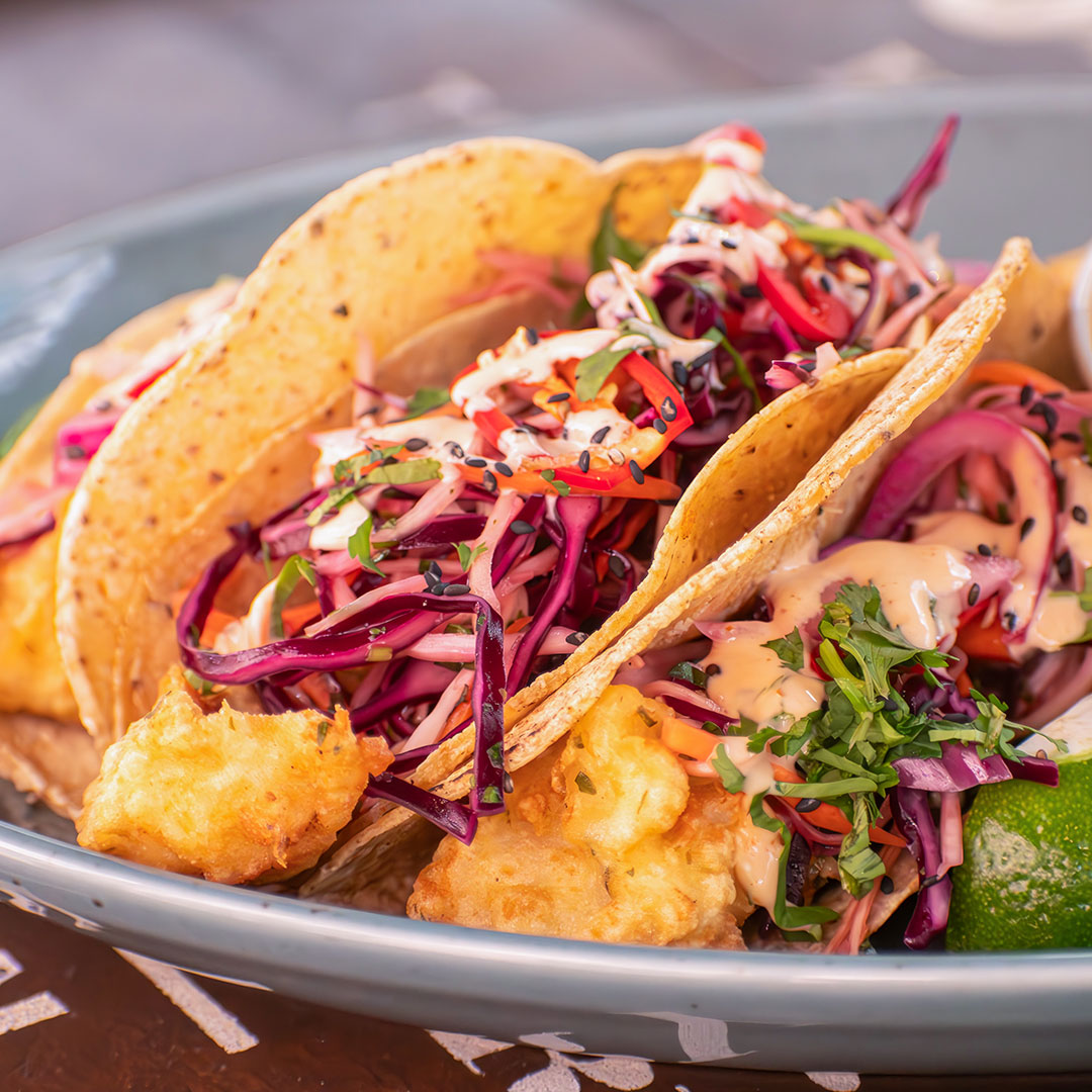 June Special dish: Fish Tacos. A trio of light, tempura-battered fish fillets served in warm corn tortillas. Accompanied by house chips. Only available in June at The Old Quarter.