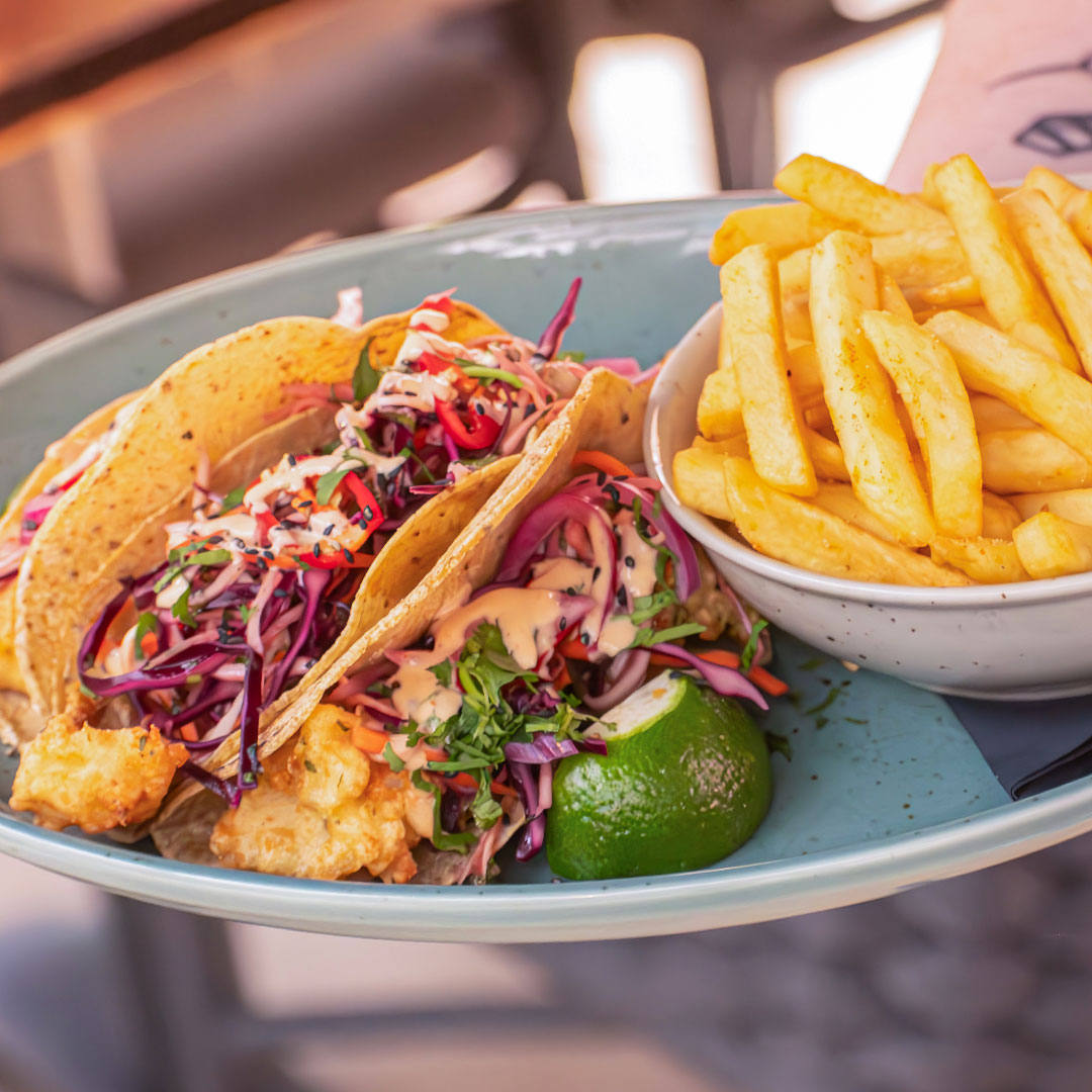 June Special dish: Fish Tacos. A trio of light, tempura-battered fish fillets served in warm corn tortillas. Accompanied by house chips. Only available in June at The Old Quarter.